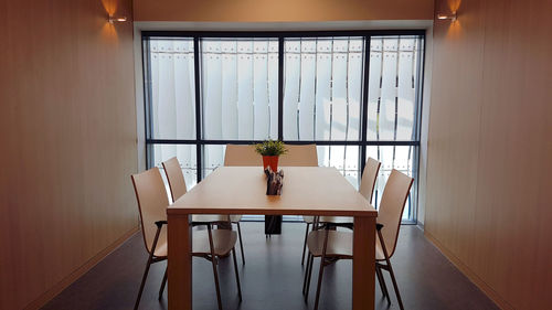 Potted plants on table by window at home