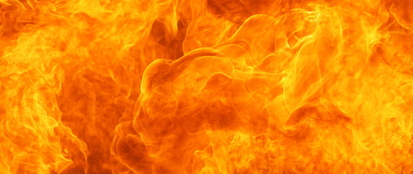 Close-up of fire on rock against black background