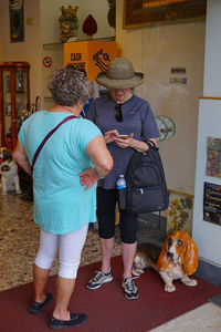 Rear view of people with dog at home