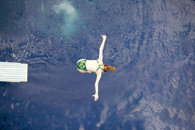 High angle view of person lying on swimming pool