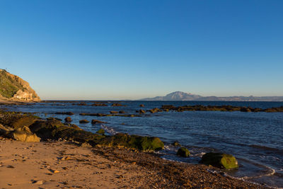 Scenic view of sea against clear blue sky