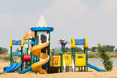 Lifeguard hut on playground against sky