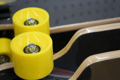 High angle view of yellow skateboard's wheels 