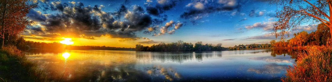 Scenic view of lake against cloudy sky