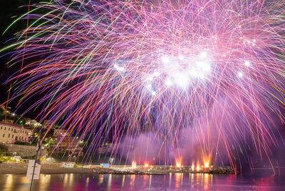Low angle view of firework display at night