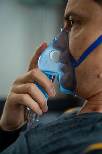 Cropped hand of man wearing mask