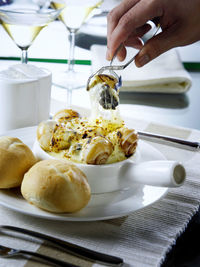 Close-up of hand holding food on table