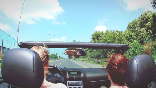 Close-up of car on road against sky