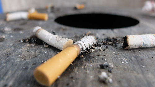 Close-up of cigarette smoking on table