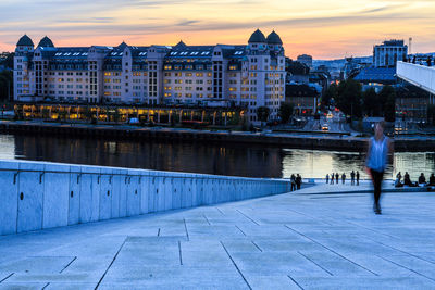 View of river in city at sunset