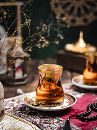 A glass of turkish tea on the table. conceptual stilllife photograhy with ramadan vibes concept