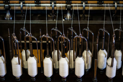 Close-up of bottles hanging in row