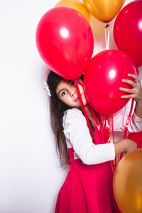 Portrait of a girl with red balloons