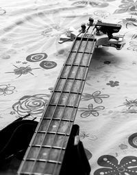 High angle view of guitar on bed