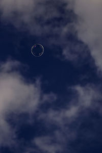 Close-up of water drop against sky