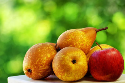 Close-up of pears and apple on table at home