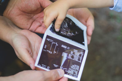 Midsection of person using mobile phone