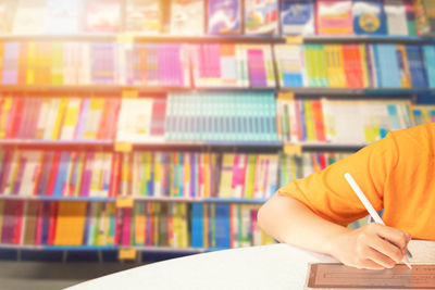 Cropped hand of woman working at library