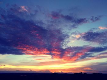 Dramatic sky over silhouette landscape