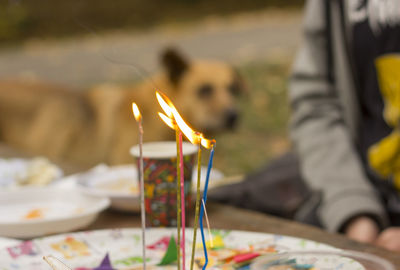 Close-up of lit candles on table