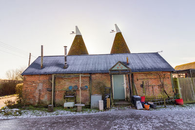 Houses against clear sky during winter