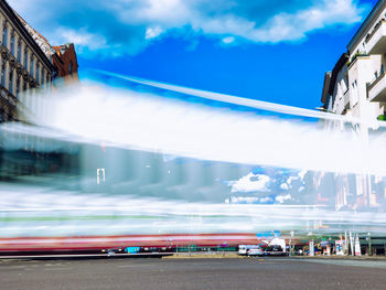 Blurred motion of vehicles on road against sky