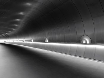 Person walking in illuminated tunnel