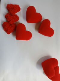 High angle view of red heart shape on white table