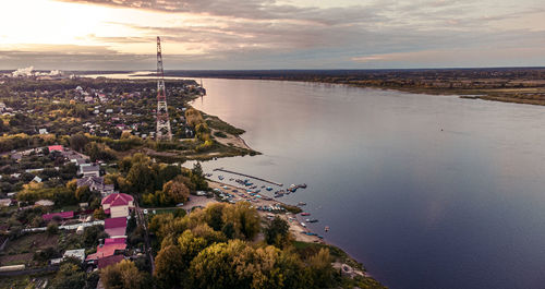 High angle view of townscape by sea against sky