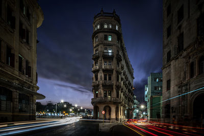Light trails on road amidst buildings in havana at night