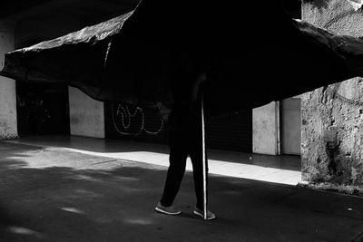 Low section of woman standing on road