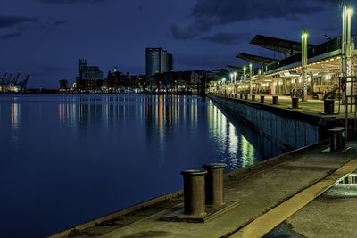 Reflection of illuminated buildings in river at night