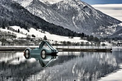 Reflection of snow in lake against mountain range