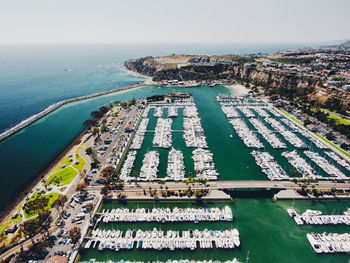 High angle view of sea and cityscape against sky