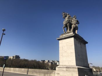 Low angle view of statue against sky