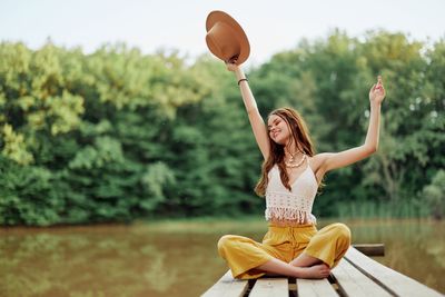 Portrait of young woman exercising in lake