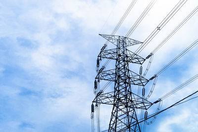 Low angle view of electricity pylon against sky