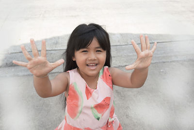 Portrait of smiling girl standing by sea