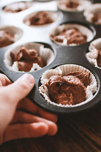 Close-up of hand holding ice cream in bowl