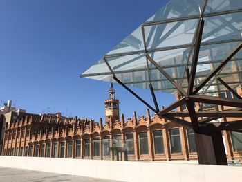 Low angle view of buildings against blue sky