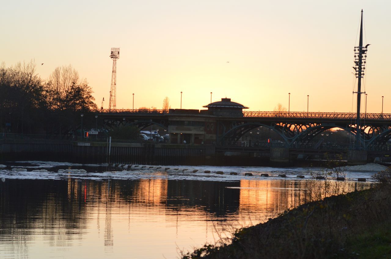 reflection, sunset, water, transportation, built structure, sky, no people, mode of transport, bridge - man made structure, outdoors, silhouette, architecture, building exterior, nature, tree, day