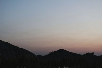 Scenic view of silhouette mountains against sky during sunset