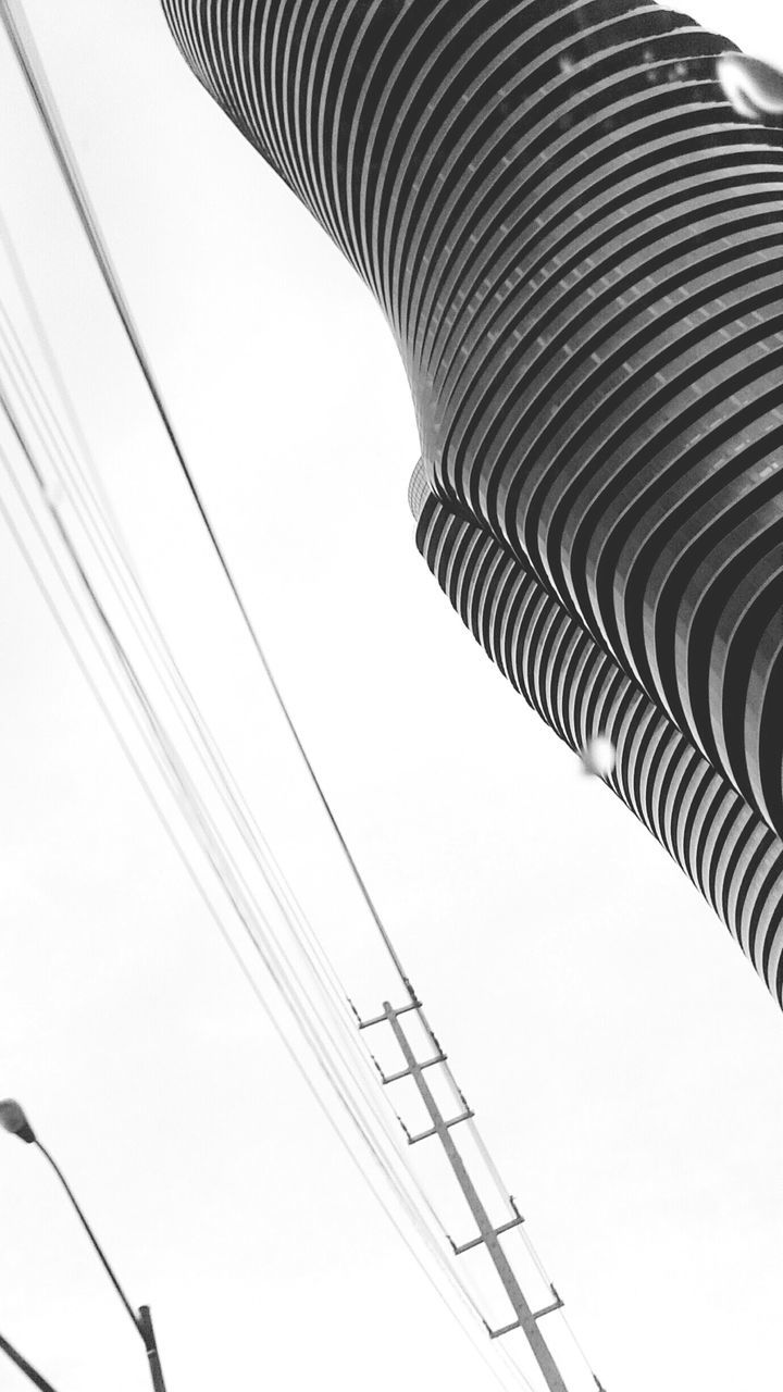 low angle view, clear sky, connection, technology, electricity, cable, metal, built structure, power line, tall - high, architecture, copy space, no people, day, modern, part of, metallic, outdoors, fuel and power generation, in a row