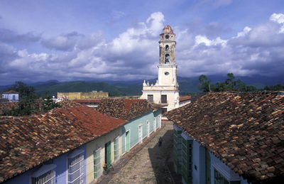 Church in town against cloudy sky