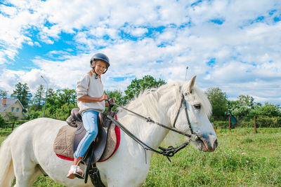 Man riding horse on field