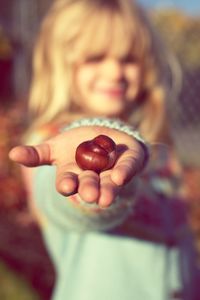 Close-up of girl holding chestnut