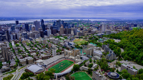 High angle view of modern buildings in city against sky