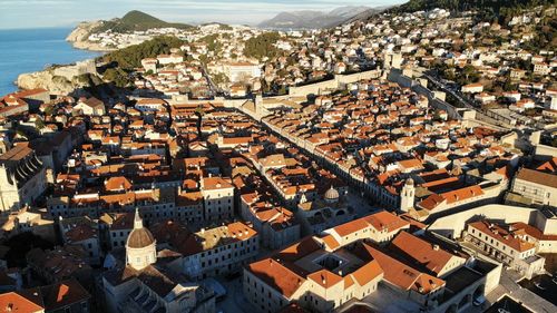 High angle view of townscape by sea