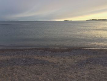 Scenic view of sea against sky at sunset