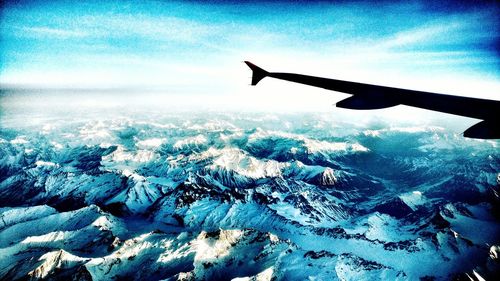 Cropped image of airplane flying over landscape
